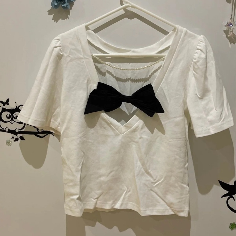 Sexy back with black bow and pearl chain white top